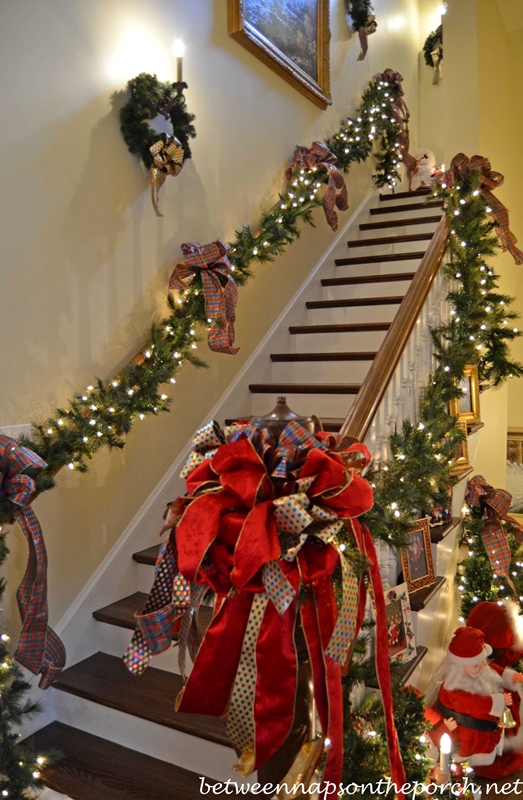 Stairway Decorated with Lit Garland and Ribbon